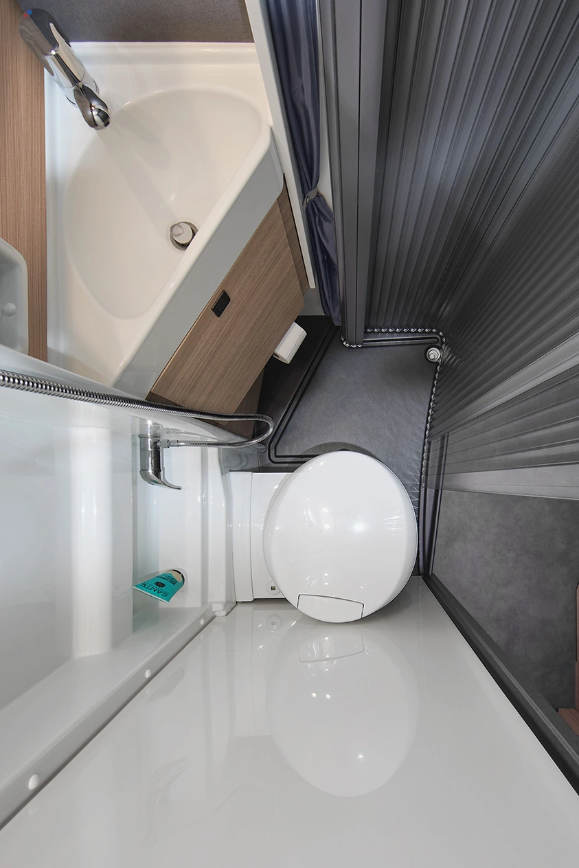 Draufsicht auf das platzsparende Bad im Malibu Relax Camper Van mit Toilette, Duschwanne und Waschbecken im kompakten Design