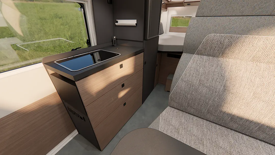 Ansicht der Küchenzeile eines Malibu Campervans mit moderner und ausklappbarer Arbeitsfläche.